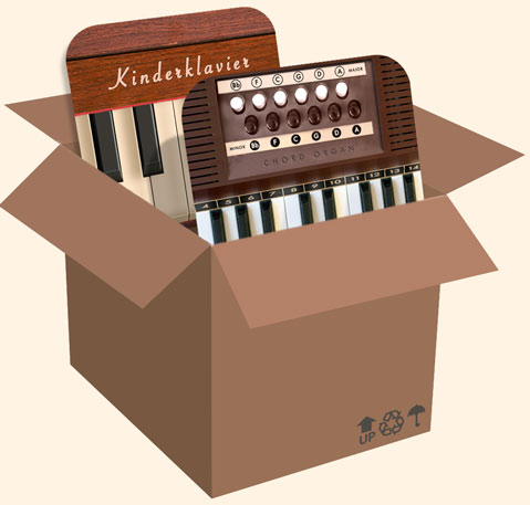 Chord Organ and Kinderklavier sitting comfortably inside a cardboard box